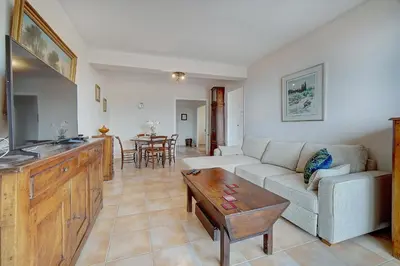 a living room with a couch and a table at IMMOGROOM - Terrace- Parking - Quiet place - CONGRESSBEACHES in Cannes