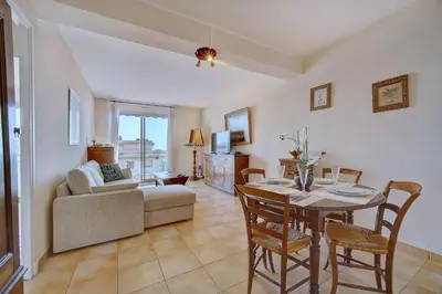 a living room with a table and a couch at IMMOGROOM - Terrace- Parking - Quiet place - CONGRESSBEACHES in Cannes