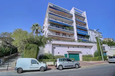 two cars parked in front of a large building at IMMOGROOM - Terrace- Parking - Quiet place - CONGRESSBEACHES in Cannes