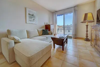 a living room with a couch and a table at IMMOGROOM - Terrace- Parking - Quiet place - CONGRESSBEACHES in Cannes