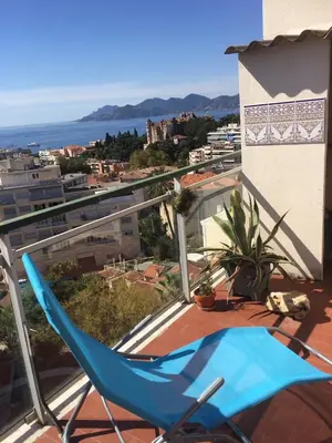 a blue chair sitting on top of a balcony at IMMOGROOM - Terrace- Parking - Quiet place - CONGRESSBEACHES in Cannes