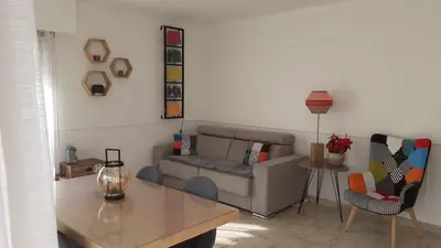 a living room with a couch and a table at Appartement raffiné Cannes in Cannes