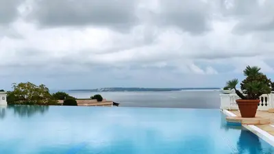 a swimming pool with a view of the water at Studio cabine vue mer, piscine panoramique, parking couvert in Cannes