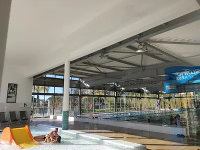 a couple of people in a swimming pool at Très beau T2 dans parc montfleury ,proche centre ,au calme 44 bd Montfleury in Cannes