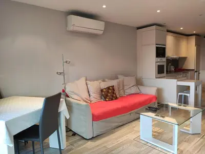 a living room with a couch and a bed at Très beau T2 dans parc montfleury ,proche centre ,au calme 44 bd Montfleury in Cannes