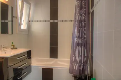 a bathroom with a shower curtain and a sink at BEL APPARTEMENT PROCHE PLAGE ET CENTRE VILLE in Cannes