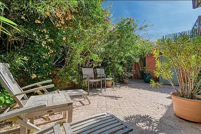 a patio with chairs and trees and plants at L'ORANGER maison pittoresque et confortable proche des plages, Croisette et centre-ville in Cannes