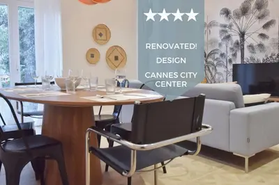 a dining room with a table and a couch at Modern 3-Br Apartment in City Center 5 Minutes from Palais and Beache in Cannes