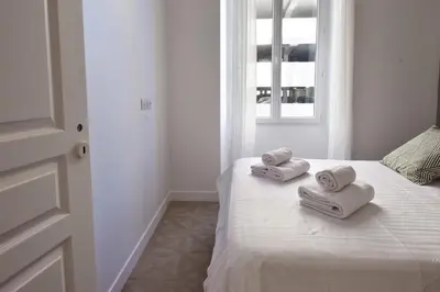 a bedroom with a bed with two towels on it at Modern 3-Br Apartment in City Center 5 Minutes from Palais and Beache in Cannes