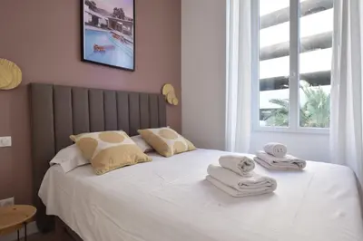 a bedroom with a bed with towels on it at Modern 3-Br Apartment in City Center 5 Minutes from Palais and Beache in Cannes