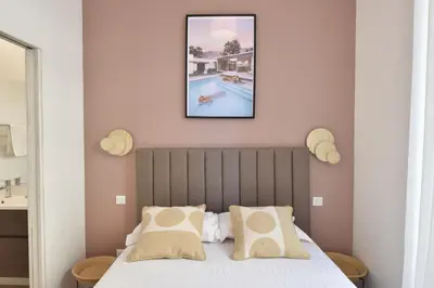 a bedroom with a bed and a swimming pool at Modern 3-Br Apartment in City Center 5 Minutes from Palais and Beache in Cannes