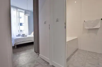 a white room with a bedroom with a bed at Modern 3-Br Apartment in City Center 5 Minutes from Palais and Beache in Cannes