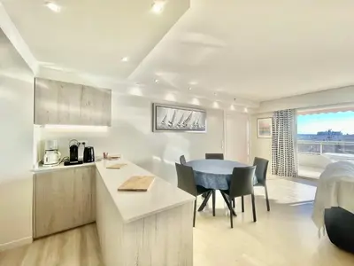 a kitchen and dining room with a table and chairs at Vezelay, by Welcome to Cannes in Cannes
