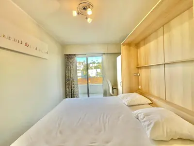 a bed with two pillows in a room with a window at Vezelay, by Welcome to Cannes in Cannes