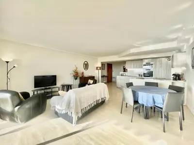 a kitchen and living room with a table and chairs at Vezelay, by Welcome to Cannes in Cannes