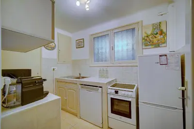 a kitchen with white appliances and a white refrigerator at Spacieux 2 Pièces Vue MER, FELIX FAURE- FORVILLE A1B047 in Cannes