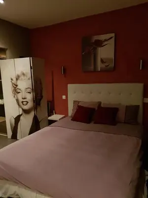 a bedroom with a bed with a picture of a woman at VILLA BEAUSEJOUR in Cannes