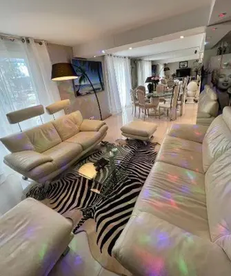 a living room with a couch and a zebra rug at VILLA BEAUSEJOUR in Cannes