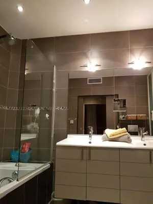 a bathroom with a sink and a shower and a mirror at VILLA BEAUSEJOUR in Cannes