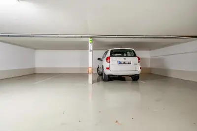 a white car parked in a parking garage at Vivre Cannes l Parking l Balcony l 15min to La Croisette in Cannes