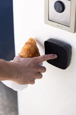 a person holding a piece of bread on a lightswitch at Vivre Cannes l Parking l Balcony l 15min to La Croisette in Cannes