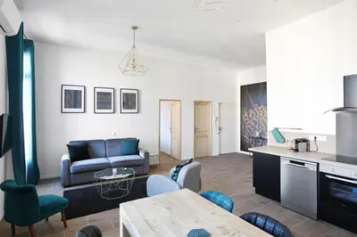 a living room with a couch and a table at Appartement Carnot - Welkeys in Cannes