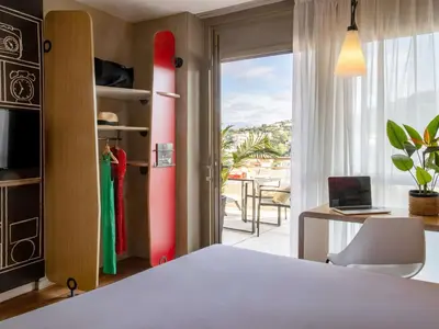 a bathroom with a shower and a sink and a mirror at ibis Cannes Plage La Bocca in Cannes