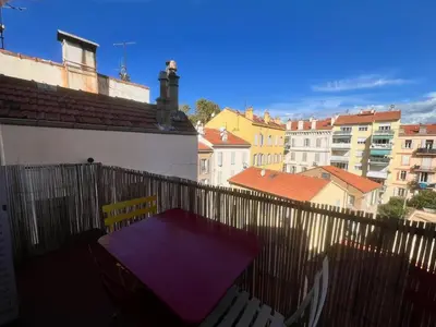 a purple table on the balcony of a building at Novembre by Welcome to Cannes in Cannes
