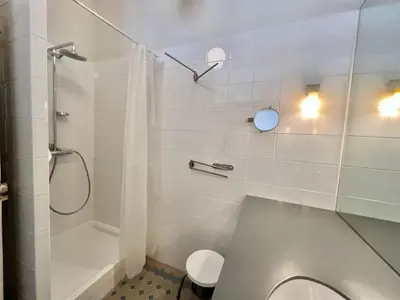 a white bathroom with a shower and a toilet at Novembre by Welcome to Cannes in Cannes