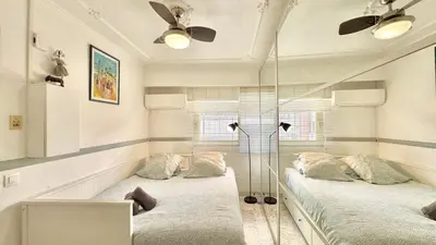 two beds in a room with two windows at Minerve by Welcome to Cannes in Cannes