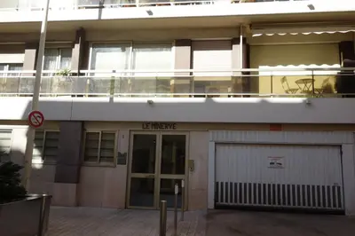 an apartment building with a garage and a balcony at Minerve by Welcome to Cannes in Cannes