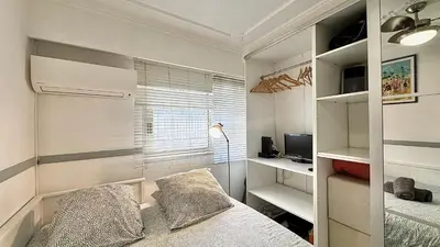 a small bedroom with a bed and a window at Minerve by Welcome to Cannes in Cannes