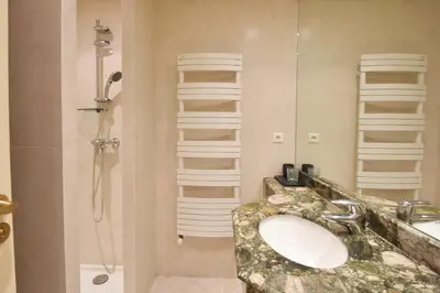 a bathroom with a sink and a shower at Close to downtown Cannes swimming pool and sea view in Cannes