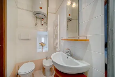 a white bathroom with a sink and a toilet at Charmant 3 pièces rue d'Antibes in Cannes