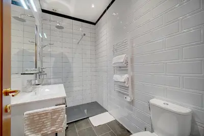 a white bathroom with a toilet and a sink at Charmant 3 pièces rue d'Antibes in Cannes