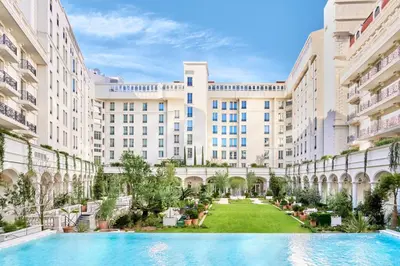 an image of the courtyard of a building with a swimming pool at Carlton Cannes, a Regent Hotel in Cannes