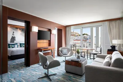 a living room with a couch and a room with a bed at JW Marriott Cannes in Cannes
