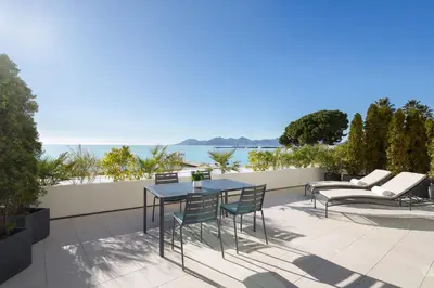 a living room with a couch and a room with a bed at JW Marriott Cannes in Cannes