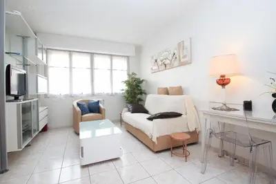 a living room with a couch and a table at Jonquille in Cannes