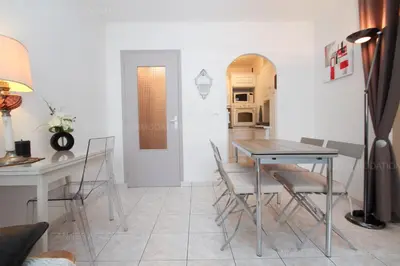 a dining room and kitchen with a table and chairs at Jonquille in Cannes