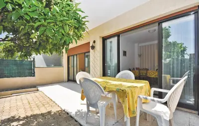 a dining table and chairs on a patio at Nice Apartment In Le Cannet With Wifi in Le Cannet