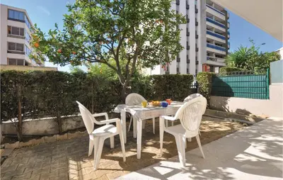 a white table and chairs on a patio at Nice Apartment In Le Cannet With Wifi in Le Cannet
