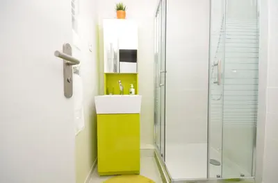 a bathroom with a yellow and white sink and a shower at One bedroom apartment Palais des festivals in Cannes