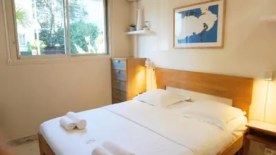 a bedroom with a bed with two towels on it at Proche Croisette, Studio Cosy by Palmazur in Cannes