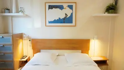 a bedroom with a bed and a picture on the wall at Proche Croisette, Studio Cosy by Palmazur in Cannes