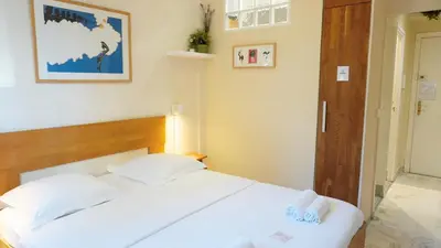 a bedroom with a white bed with two white pillows at Proche Croisette, Studio Cosy by Palmazur in Cannes