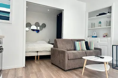 a living room with a couch and a table and a mirror at Charming 2-bedroom apartment with quality amenities in Old Cannes in Cannes