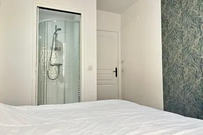 a bedroom with a bed and a glass shower at Charming 2-bedroom apartment with quality amenities in Old Cannes in Cannes