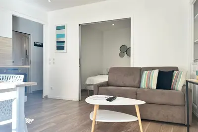 a living room with a couch and a table at Charming 2-bedroom apartment with quality amenities in Old Cannes in Cannes