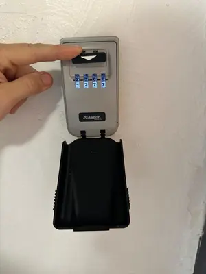 a person holding a electronic device on a wall at Lion's Room - 2 minute walk from Palais des Festivals and Beaches in Cannes